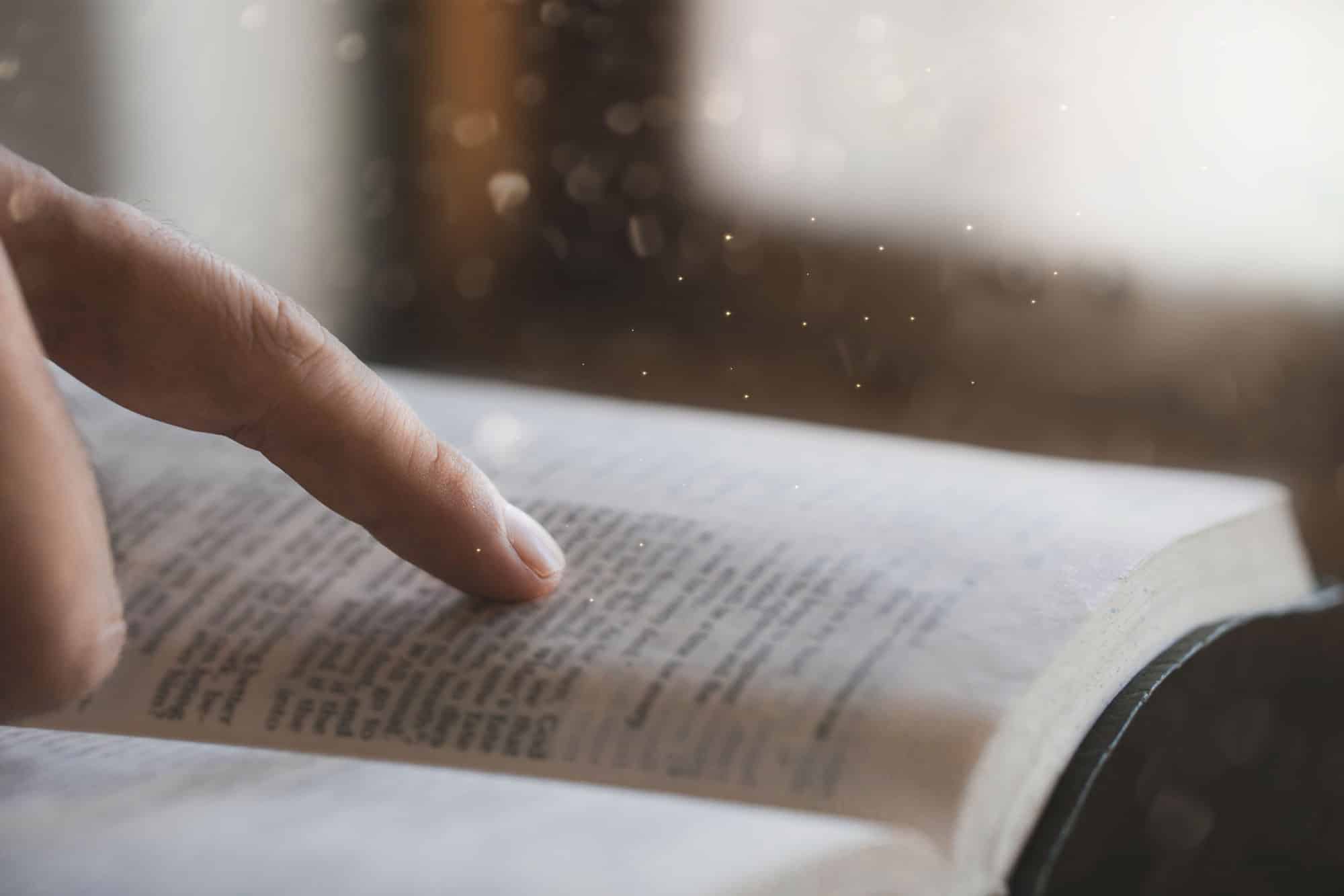 a young man is reading the bible